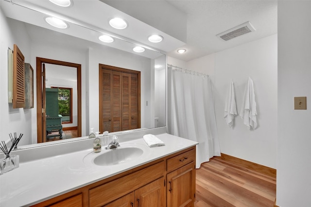 35 Toxaway Landing Dr, Lake Toxaway, NC 28747 - bathroom with vanity, wood finished floors, a closet, recessed lighting, and a shower with shower curtain