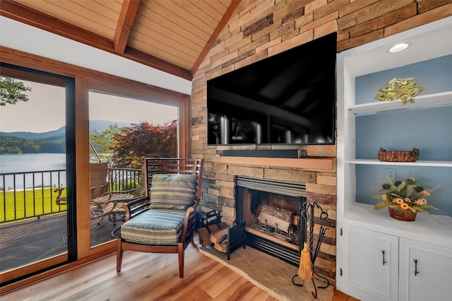 35 Toxaway Landing Dr, Lake Toxaway, NC 28747 - sitting room with wooden ceiling, wood finished floors, a stone fireplace, and a water view