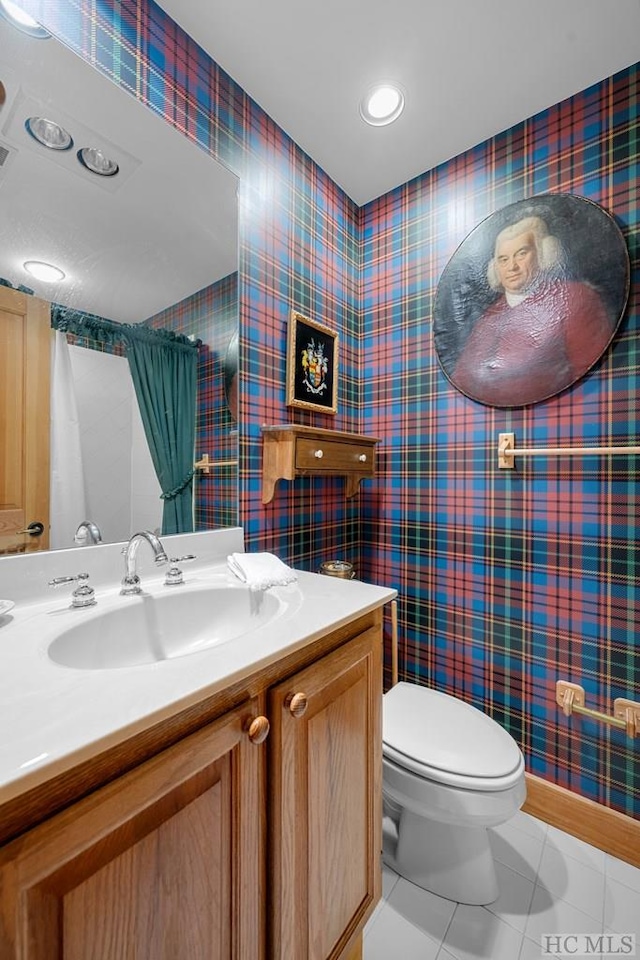 bathroom with vanity, tile patterned floors, and toilet