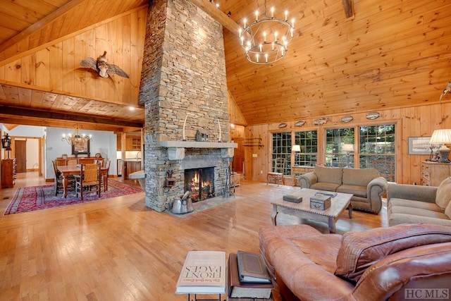 living room with wood ceiling, wood walls, high vaulted ceiling, and a notable chandelier