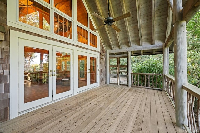 unfurnished sunroom featuring vaulted ceiling with beams and ceiling fan