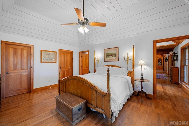 bedroom with vaulted ceiling, light wood-type flooring, wooden ceiling, and ceiling fan