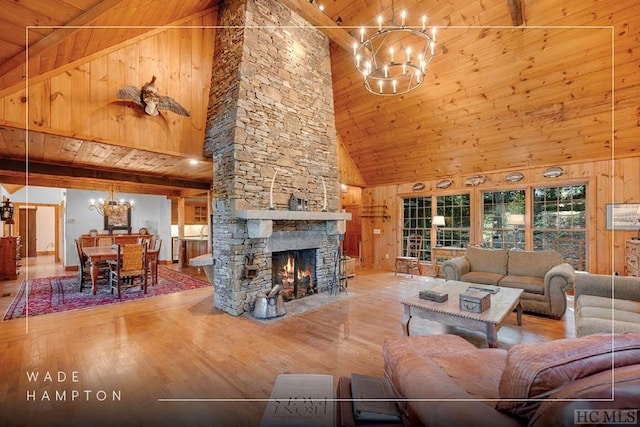 living room featuring an inviting chandelier, wooden walls, and high vaulted ceiling