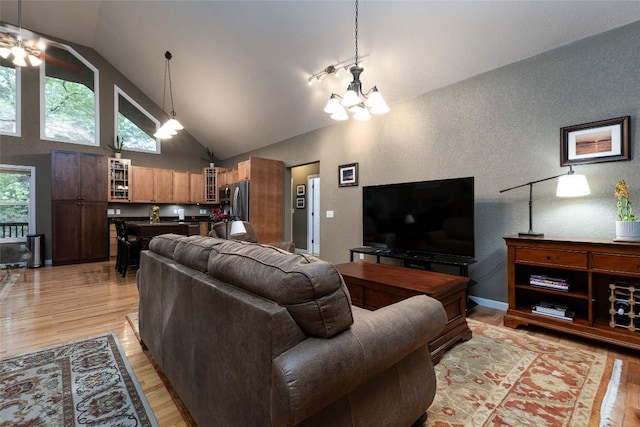 60 Pine Cone Ct, Sapphire, NC 28774 - living room featuring light wood-type flooring, a textured wall, a chandelier, high vaulted ceiling, and a ceiling fan