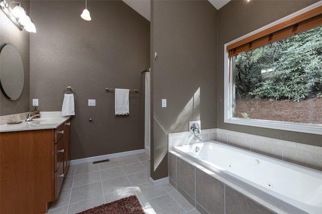 60 Pine Cone Ct, Sapphire, NC 28774 - bathroom with vanity, a tub with jets, tile patterned floors, and baseboards
