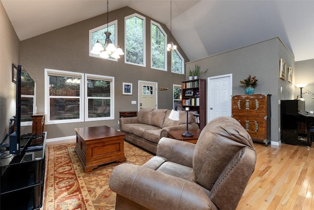 60 Pine Cone Ct, Sapphire, NC 28774 - living room with a chandelier, high vaulted ceiling, light wood-type flooring, and baseboards