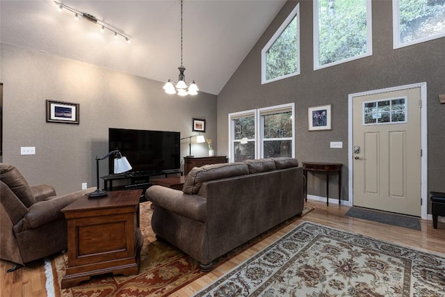 60 Pine Cone Ct, Sapphire, NC 28774 - living room featuring high vaulted ceiling, a chandelier, light wood-style floors, and track lighting