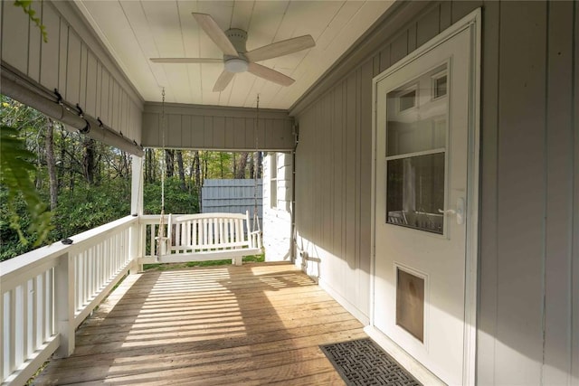 wooden terrace with a ceiling fan