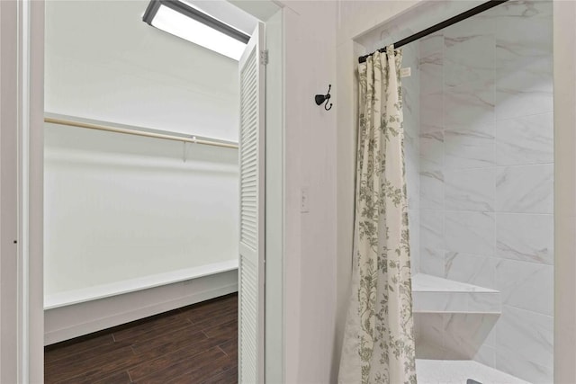 full bathroom with a shower stall and wood finished floors
