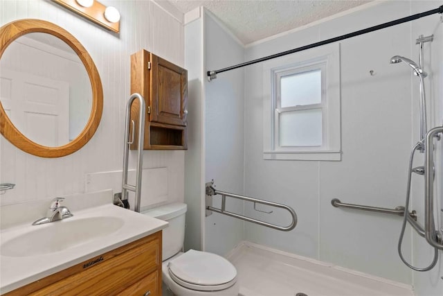 bathroom featuring a shower stall, a textured ceiling, toilet, crown molding, and vanity
