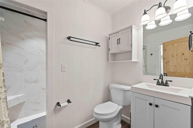 full bathroom featuring tiled shower, toilet, vanity, ornamental molding, and a chandelier