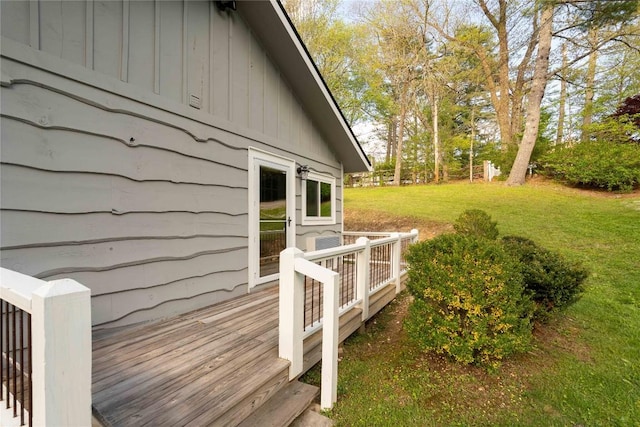 wooden deck featuring a lawn