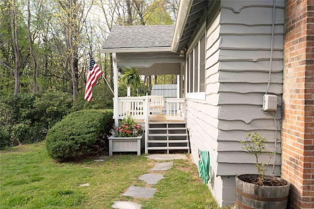 view of home's exterior with a yard and a shingled roof