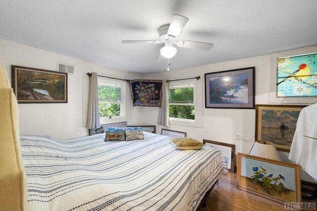 bedroom featuring ceiling fan and dark hardwood / wood-style flooring