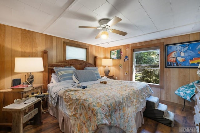 bedroom with dark hardwood / wood-style flooring and ceiling fan