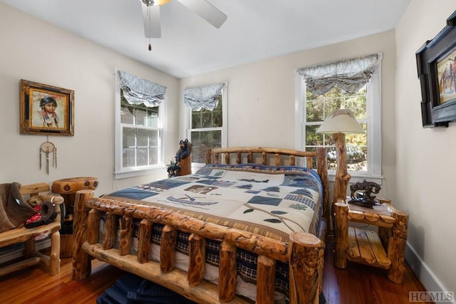 bedroom with ceiling fan and dark hardwood / wood-style flooring