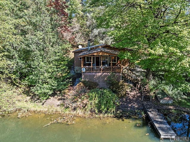 back of house with a deck with water view