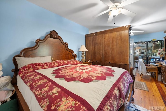 bedroom with wood-type flooring and ceiling fan