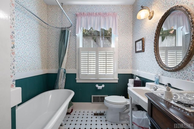 full bathroom featuring plus walk in shower, a healthy amount of sunlight, tile patterned floors, and toilet