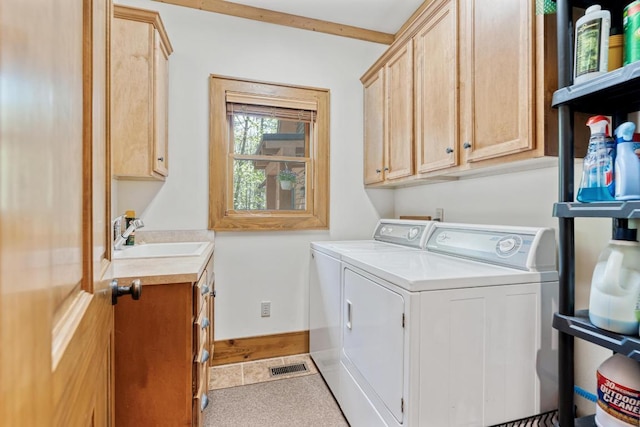 clothes washing area featuring washer and dryer and cabinet space