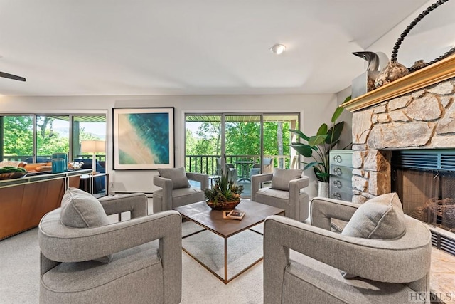 living room with a stone fireplace