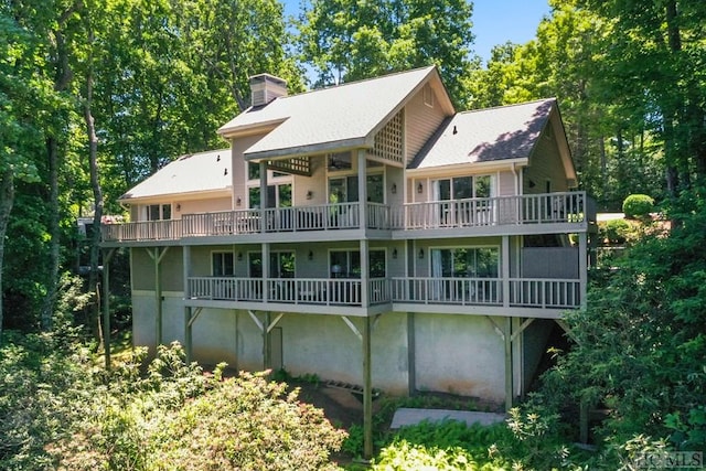 rear view of property with ceiling fan