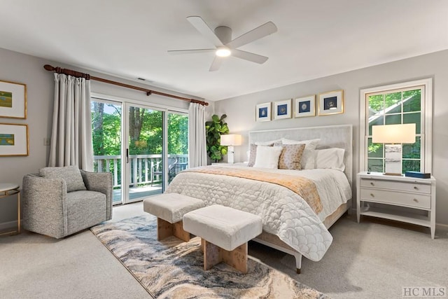 carpeted bedroom with multiple windows, access to outside, and ceiling fan