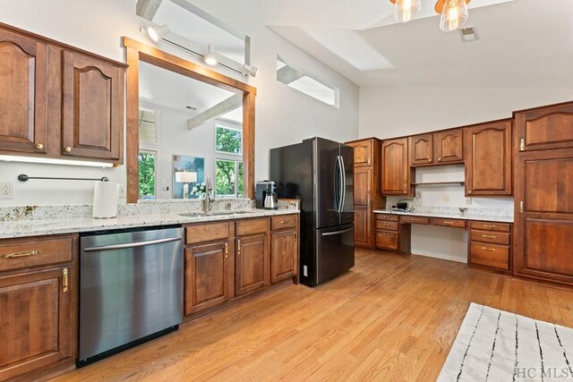 kitchen featuring sink, light hardwood / wood-style flooring, refrigerator, built in desk, and stainless steel dishwasher