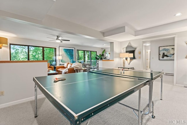 game room with ceiling fan, light colored carpet, a healthy amount of sunlight, and baseboard heating