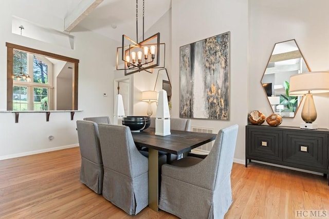 dining room featuring a chandelier, beam ceiling, and light hardwood / wood-style floors