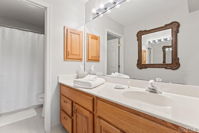 bathroom with vanity, toilet, and tile patterned flooring