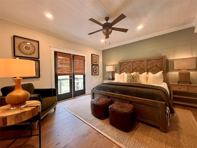 bedroom with wooden ceiling, recessed lighting, wood finished floors, and access to exterior