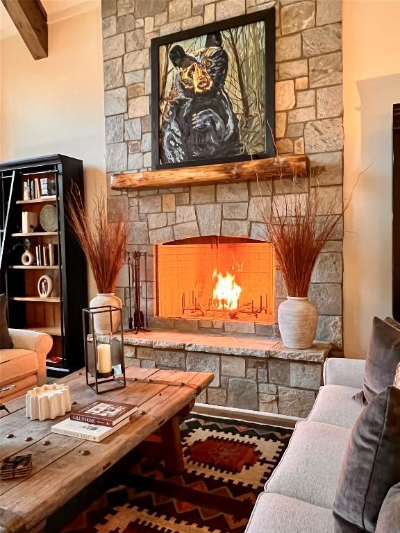living area with beam ceiling and a fireplace