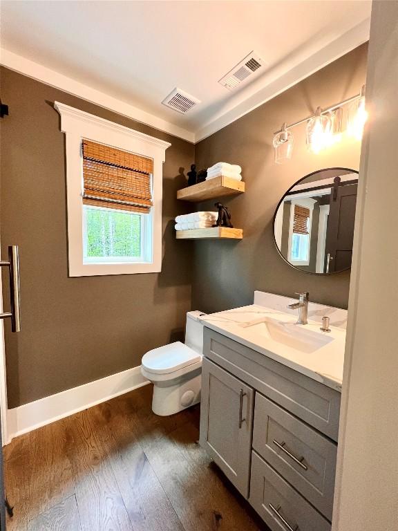 207 Comanche Rd, Cullowhee, NC 28723 - bathroom featuring vanity, wood finished floors, toilet, and baseboards