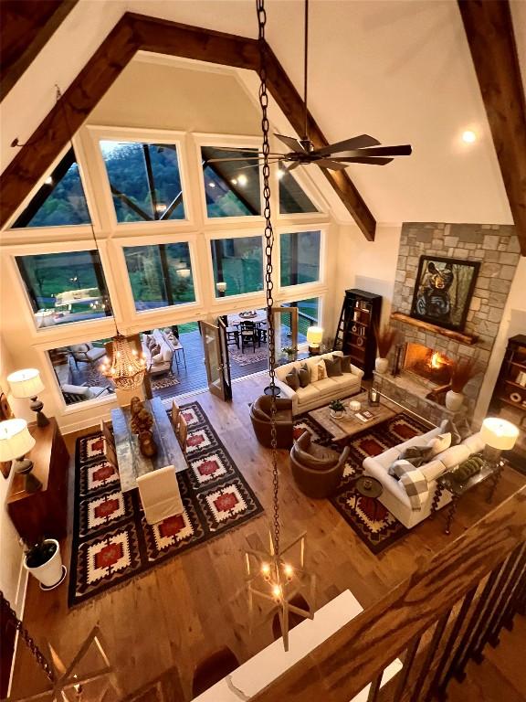 living room with high vaulted ceiling, ceiling fan, and wood finished floors