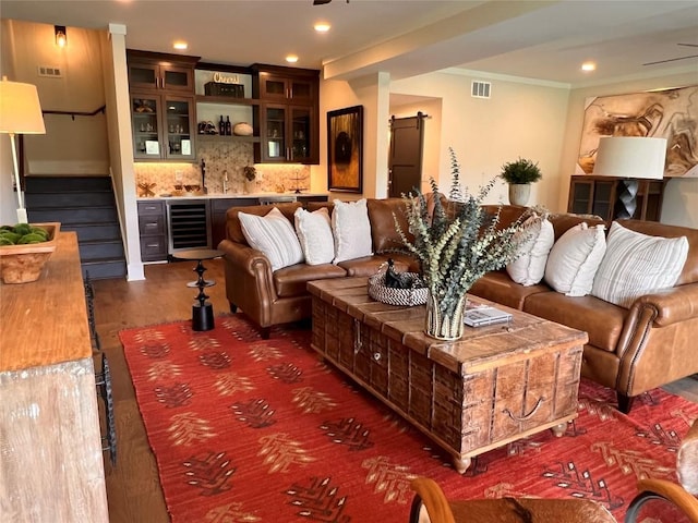 living room featuring stairs, recessed lighting, wet bar, wine cooler, and visible vents