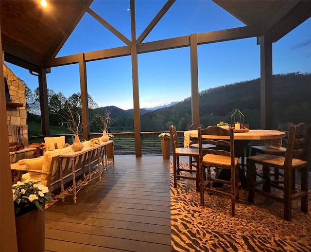 wooden terrace featuring a mountain view, outdoor dining area, and outdoor lounge area