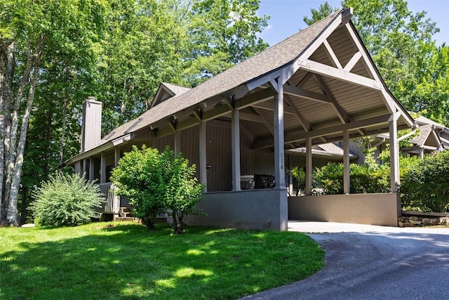 116 Fairway Villas Dr Unit D, Sapphire, NC 28774 - view of side of home featuring a shingled roof, a lawn, and a chimney