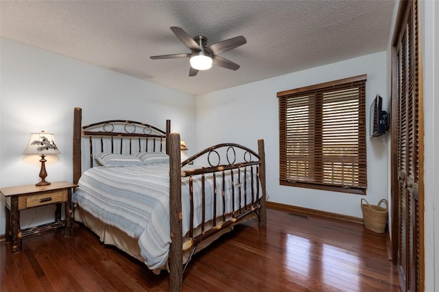 116 Fairway Villas Dr Unit D, Sapphire, NC 28774 - bedroom featuring hardwood / wood-style floors, a textured ceiling, ceiling fan, and a closet