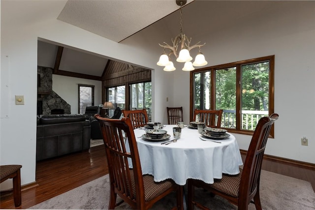 116 Fairway Villas Dr Unit D, Sapphire, NC 28774 - dining area featuring vaulted ceiling, wood finished floors, and a chandelier
