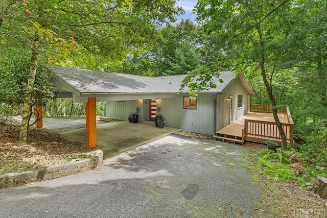 view of home's exterior with a carport and a deck