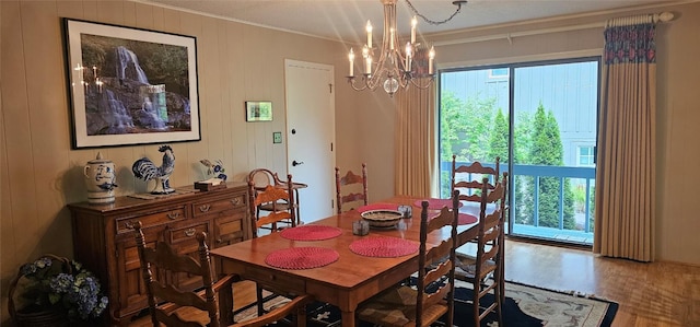 239 Island Point Rd, Lake Toxaway, NC 28747 - dining area with ornamental molding, wood finished floors, a chandelier, and wood walls