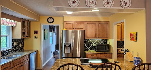 239 Island Point Rd, Lake Toxaway, NC 28747 - kitchen featuring appliances with stainless steel finishes, a sink, brown cabinets, wood finished floors, and tasteful backsplash