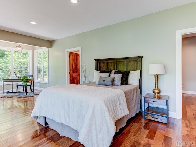 bedroom with hardwood / wood-style floors