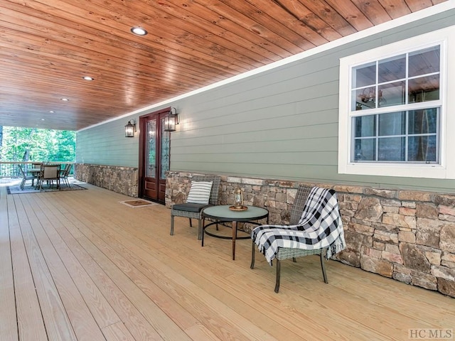 wooden terrace featuring covered porch