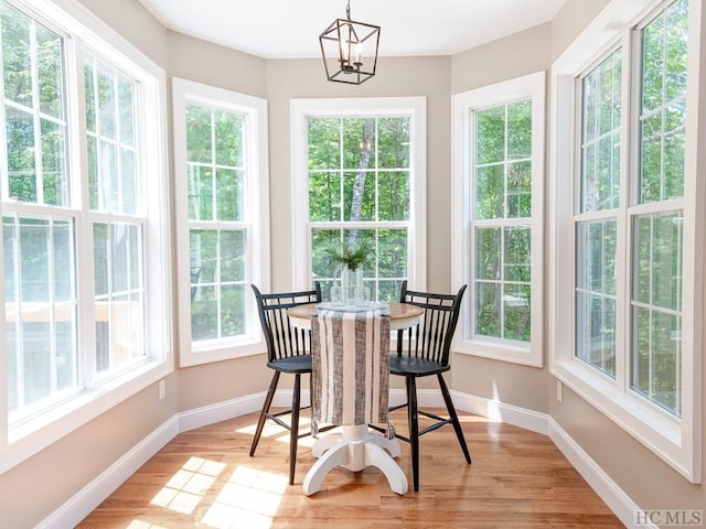 sunroom featuring an inviting chandelier