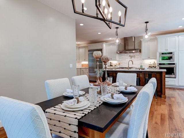 dining room with light hardwood / wood-style flooring and sink