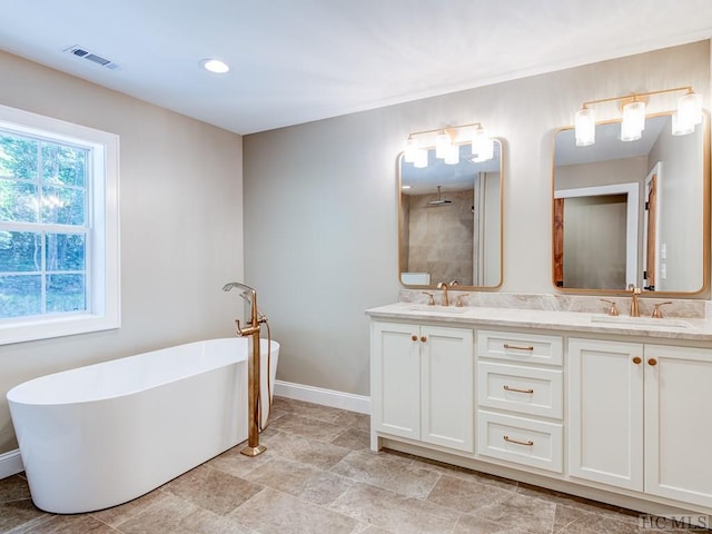 bathroom with vanity and shower with separate bathtub