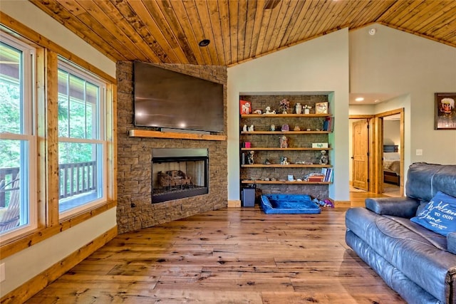 living room with lofted ceiling, hardwood / wood-style floors, and a wealth of natural light