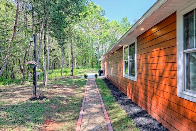 view of yard with a view of trees
